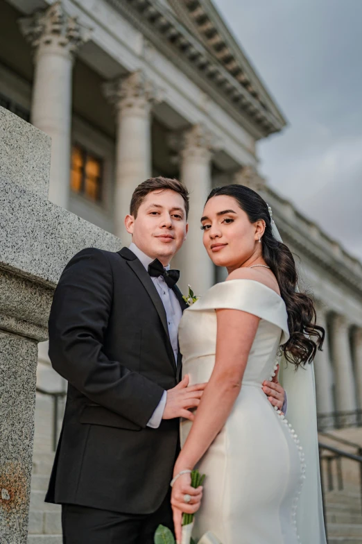 a bride and groom standing in front of a building, capitol building, pablo carpio and jordan grimmer, square, high-quality photo