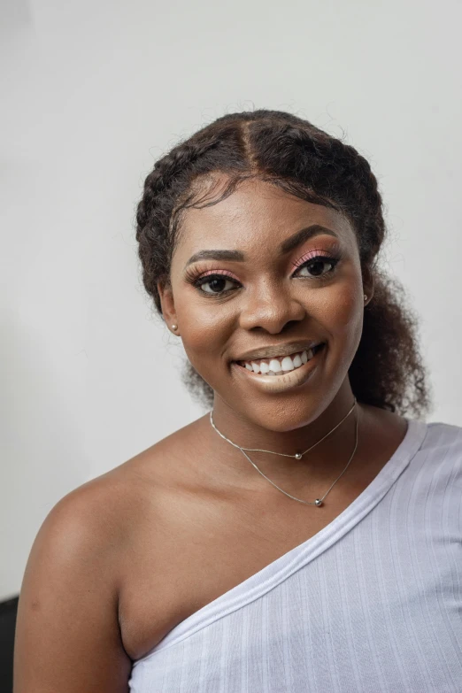 a woman in a white top posing for a picture, inspired by Chinwe Chukwuogo-Roy, trending on pexels, thick eyebrows, dramatic smiling pose, close - up studio photo, avatar image