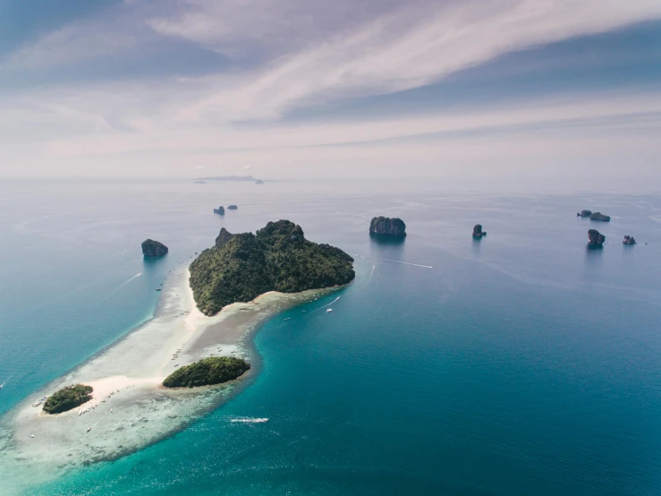 a small island in the middle of the ocean, pexels contest winner, in style of thawan duchanee, epic land formations, thumbnail, scattered islands