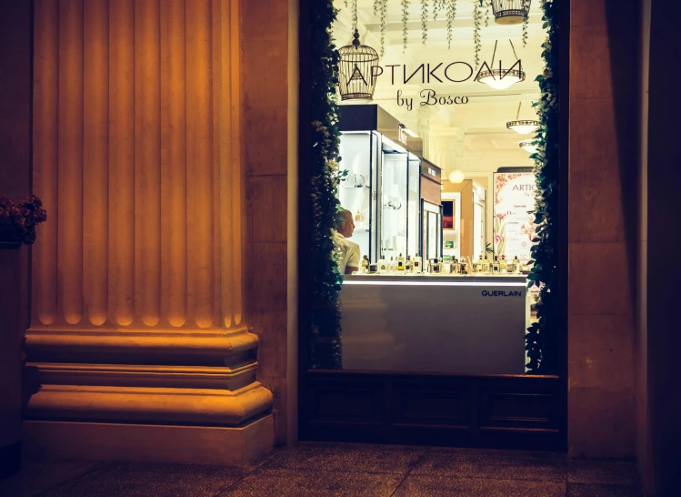 a store front is lit up at night, by Julia Pishtar, russian neoclassicism, jewelry lighting, epicurious, rokoko