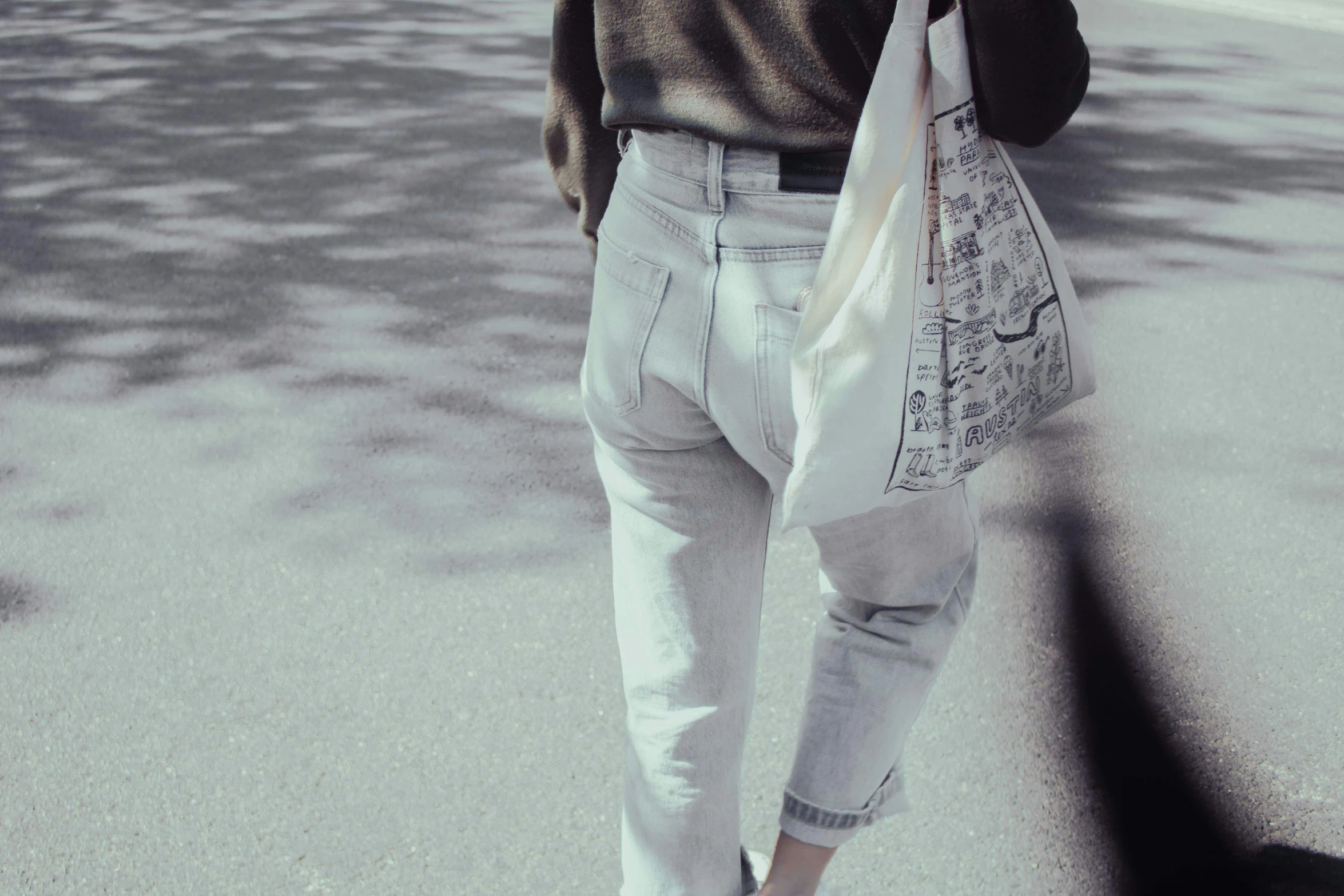 a woman walking down a street while talking on a cell phone, pexels contest winner, baggy jeans, made in tones of white and grey, newspaper, showing her shoulder from back