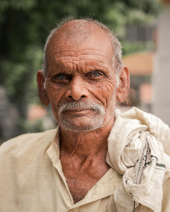 a man with a bag on his shoulder, a character portrait, inspired by Steve McCurry, pexels contest winner, prideful look, old male, indian, non binary model