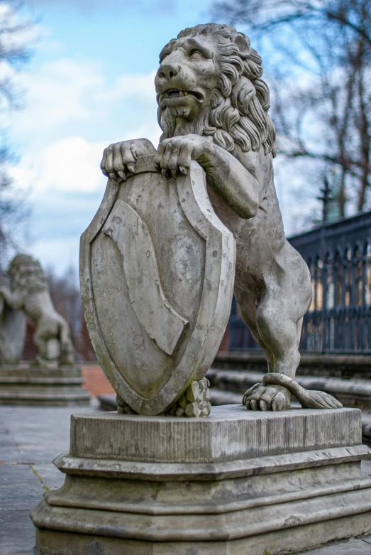 a statue of a lion holding a shield, a statue, by Adam Szentpétery, finland, fan favorite, barriers, very elegant features