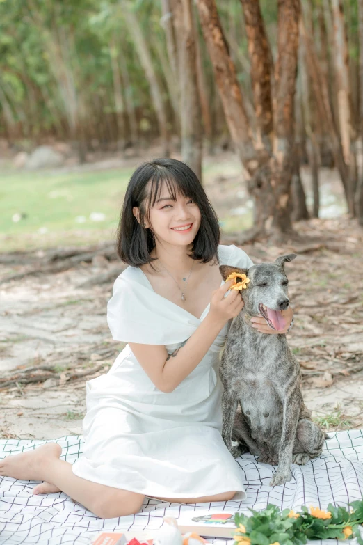 a woman sitting on a blanket with a dog, by Tan Ting-pho, pexels contest winner, realism, on a tree, ulzzang, eating cheese, headshot profile picture