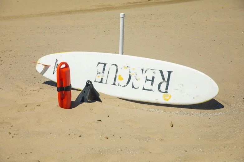 a white surfboard sitting on top of a sandy beach, pexels contest winner, plasticien, reddish, emergency, o'neill cylinder, sign