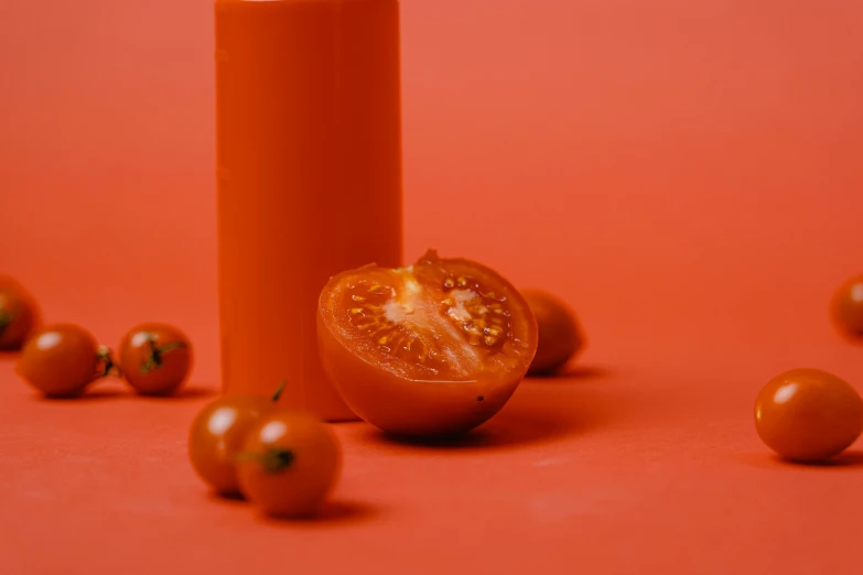 a candle and some tomatoes on a red surface, pexels contest winner, orange skin. intricate, set against a white background, pastel', ignant