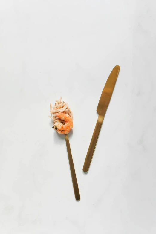 a close up of a fork and a knife on a table, inspired by Barthélemy Menn, arabesque, shrimp, gold flakes, mayo, ultra minimalistic