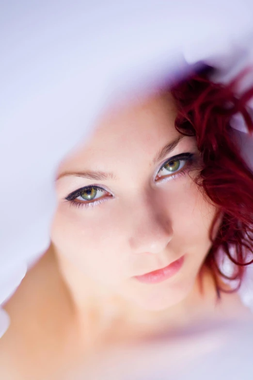 a close up of a woman with red hair, an album cover, inspired by Pierre Auguste Cot, unsplash, purple eyes and white dress, color photograph portrait 4k, low - angle shot, square