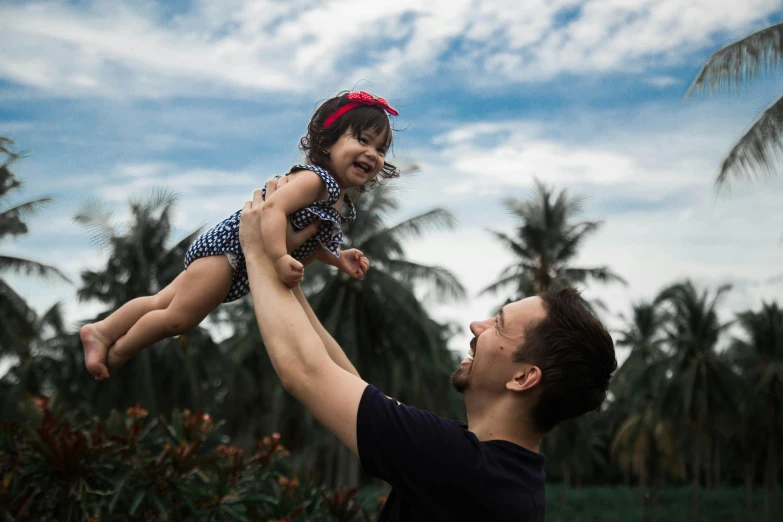 a man holding a little girl up in the air, pexels contest winner, symbolism, avatar image, malaysian, profile image, scientific photo