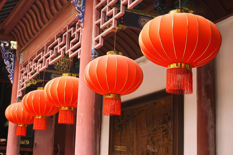 a group of red lanterns hanging from the side of a building, a picture, inspired by Qian Du, orange lamp, chinese architecture, 🦩🪐🐞👩🏻🦳, light fixtures