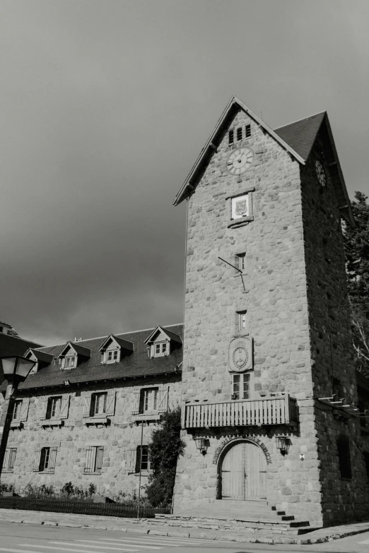 a black and white photo of an old building, inspired by Pierre Toutain-Dorbec, unsplash, romanesque, watch tower, alpine architecture, french village exterior, square