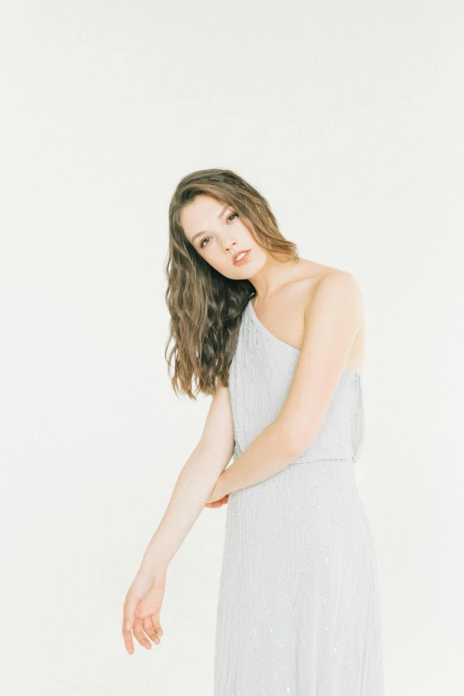 a woman in a gray dress posing for a picture, smooth pale skin, white background : 3, cynthwave, trending photo