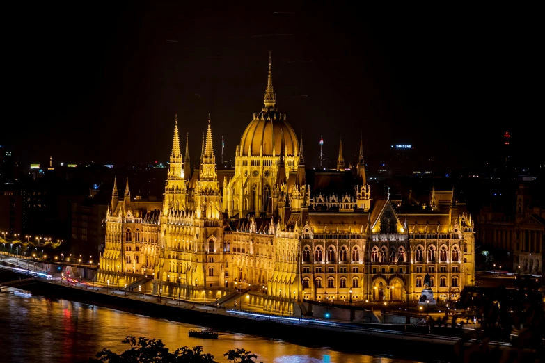 a large building lit up at night next to a river, pexels contest winner, baroque, parliament, gigapixel photo, thumbnail, austro - hungarian