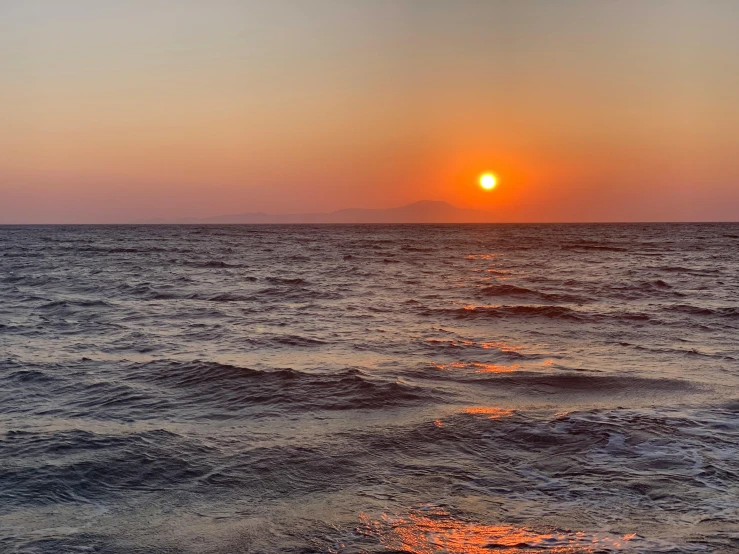 the sun is setting on the horizon of the ocean, a picture, pexels contest winner, romanticism, alexandros pyromallis, view from the sea, 2022 photograph, slide show