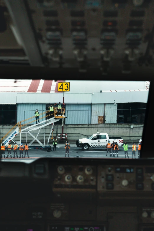 a view from inside the cockpit of a plane, inspired by Andreas Gursky, happening, sitting in a crane, people at work, airport, flying emergency vehicles