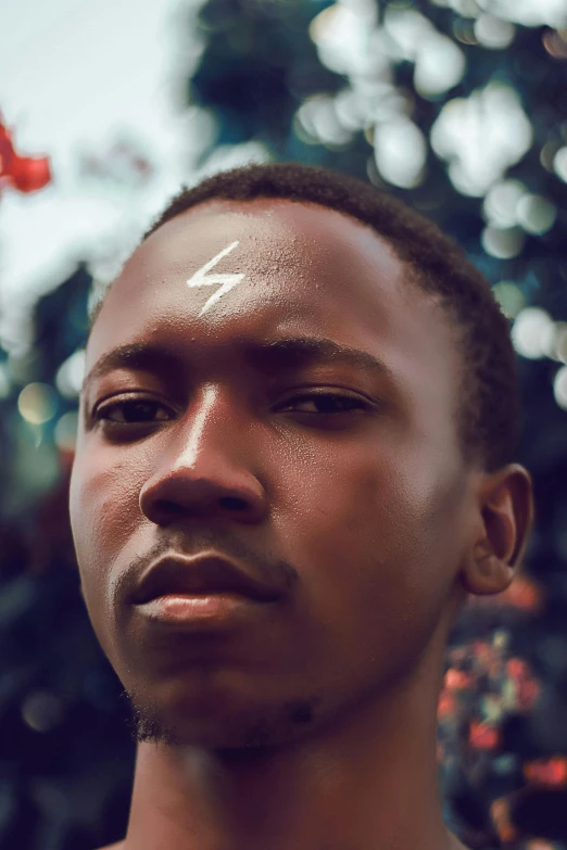 a man standing in front of a christmas tree, an album cover, trending on pexels, afrofuturism, lightning bolt scar on forehead, 1 7 - year - old boy thin face, headshot profile picture, massai warrior