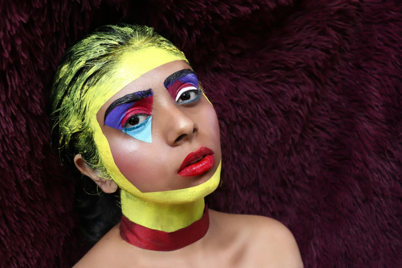 a woman with yellow and red paint on her face, an album cover, inspired by Man Ray, trending on pexels, portrait of sherlyn chopra, fullbody painting, face accessories, wearable art