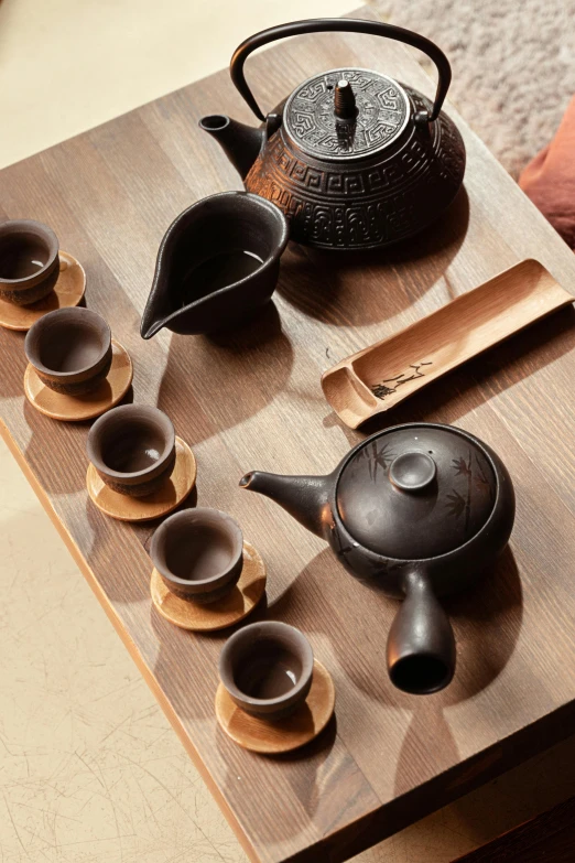 a tea set sitting on top of a wooden table, negao, square, medium, displayed