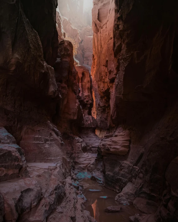 a person standing in the middle of a narrow canyon, unsplash contest winner, tonalism, red sandstone natural sculptures, cozy environment, from 8 k matte, rainbow trail