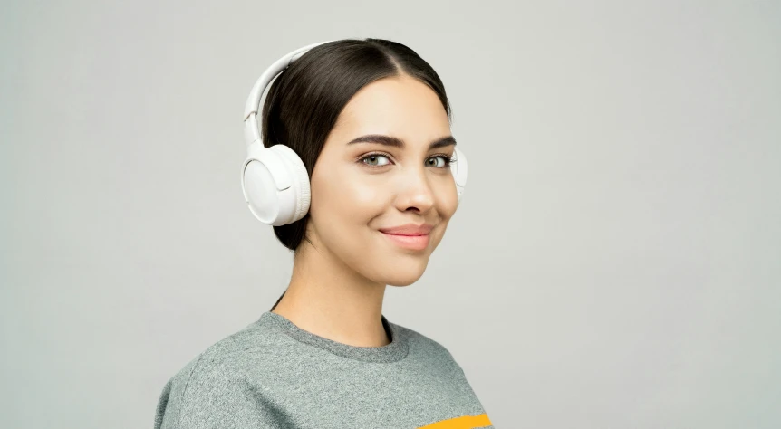 a close up of a person wearing headphones, white wearing, pixvy, a beautiful woman in white, on a gray background