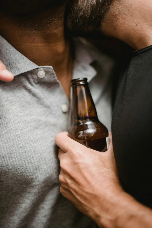 a close up of a person holding a beer bottle, by Adam Marczyński, two men hugging, profile image, sparse chest hair, brown