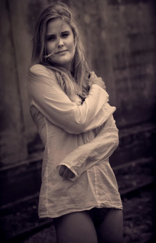 a black and white photo of a woman posing for a picture, a black and white photo, in muted colours, desaturated!!, white sleeves, young blonde woman