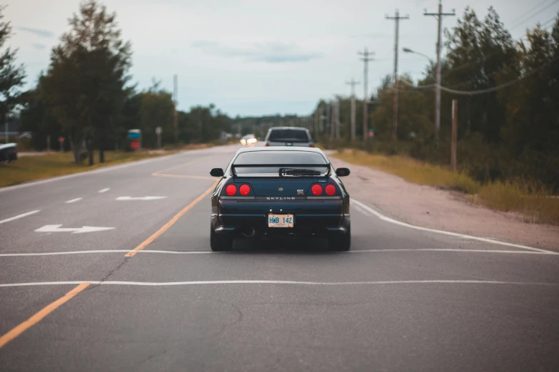 a car that is sitting in the middle of the road, a picture, by Niko Henrichon, pexels contest winner, 80s outrun, thick tail, forward facing, 🚿🗝📝