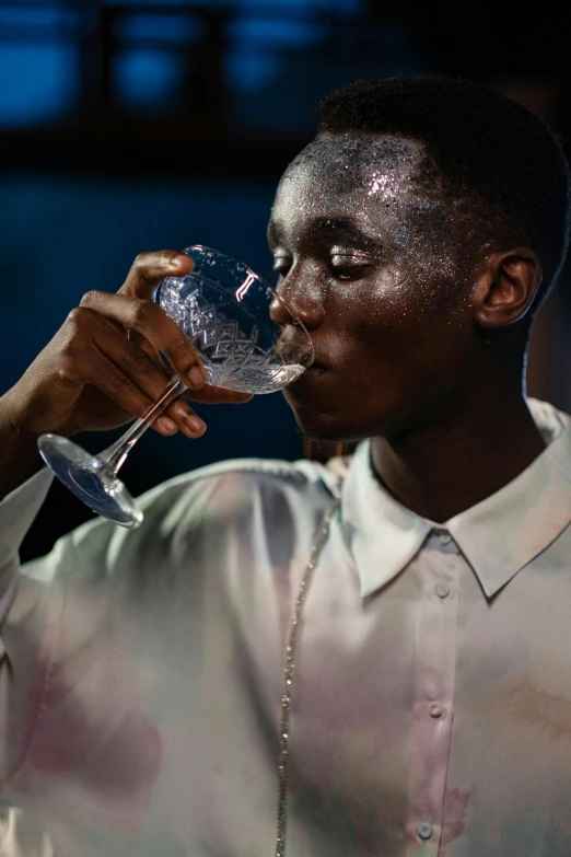 a man is drinking from a wine glass, a hyperrealistic painting, inspired by Jan Lievens, trending on unsplash, lupita nyong'o, shimmering iridescent water, androgynous male, bartending