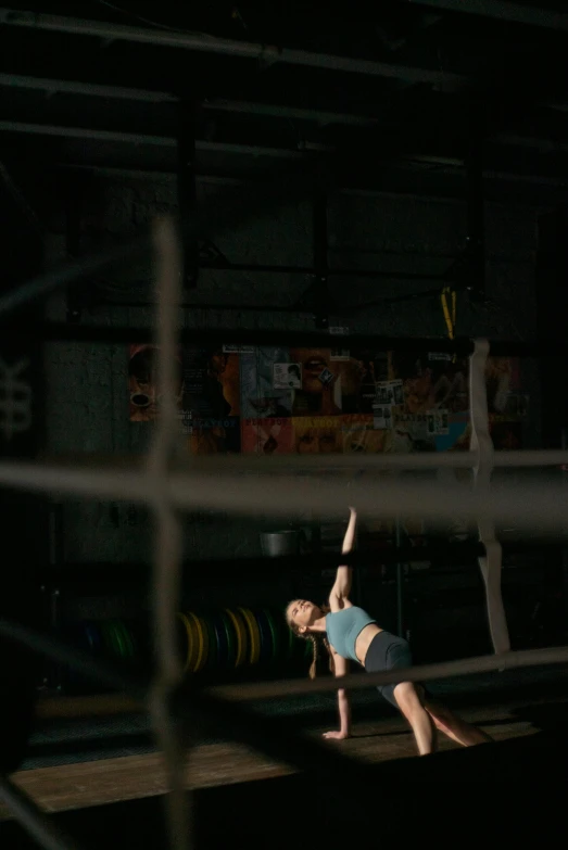 a woman doing a handstand in a gym, a portrait, by Tom Bonson, pexels contest winner, arabesque, cage, athletic crossfit build, ::