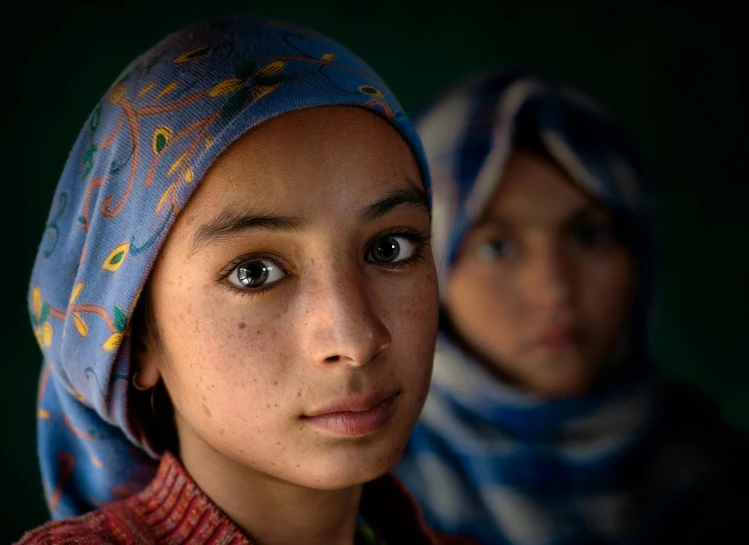 two young girls wearing headscarves and scarves, an album cover, inspired by Steve McCurry, portrait 8 k, slide show, looking serious, high - resolution