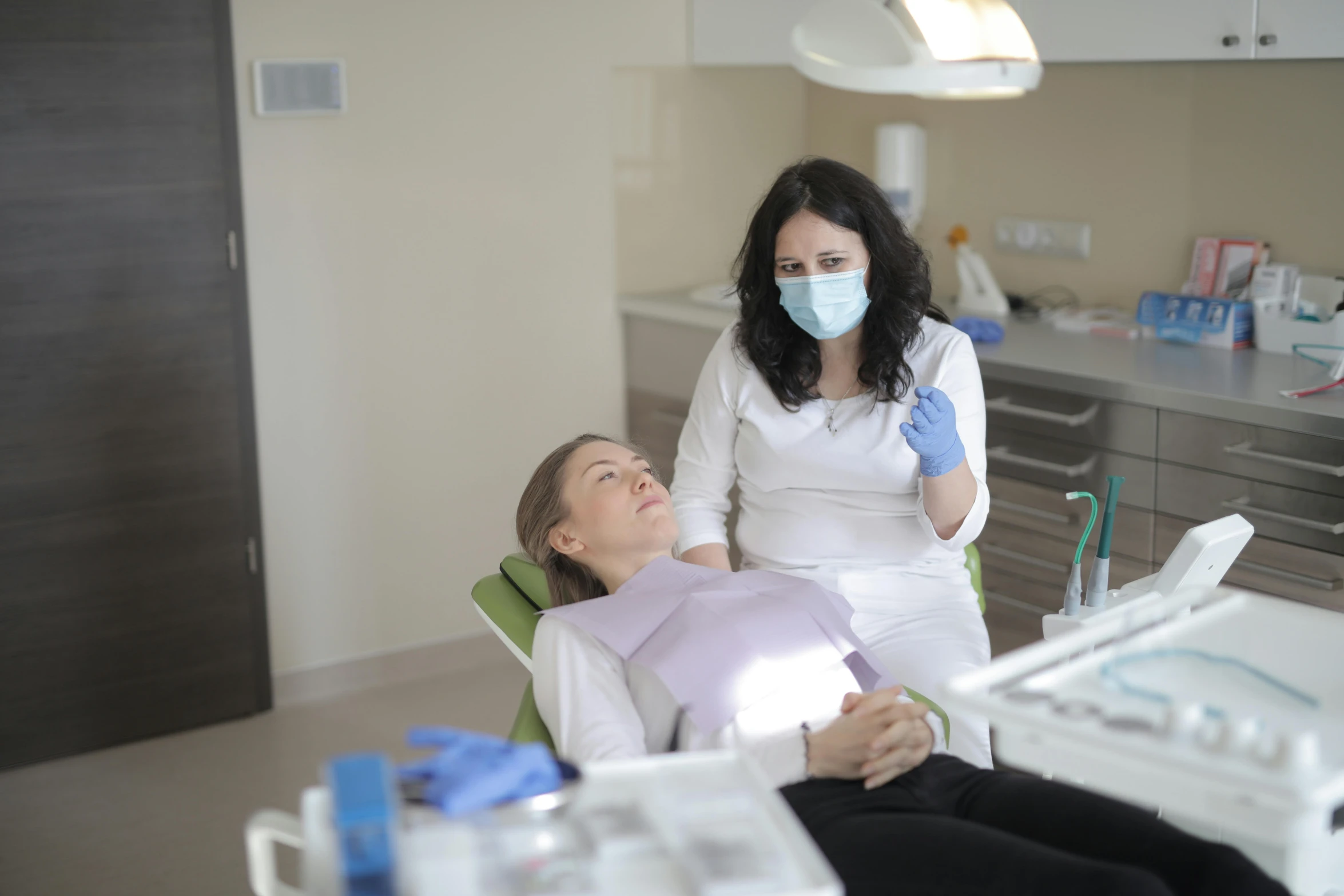 a woman getting her teeth examined by a dentist, by Adam Marczyński, pexels contest winner, hurufiyya, avatar image, sad look, full figure, 15081959 21121991 01012000 4k