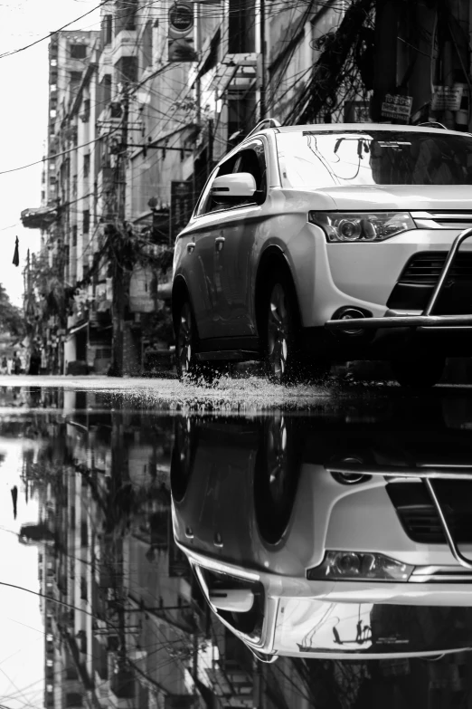 a reflection of a car in a puddle of water, a black and white photo, by Cafer Bater, cinematic. by leng jun, square, crossover, in style of lam manh