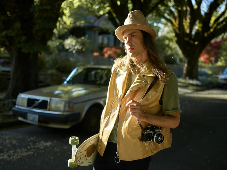 a woman wearing a hat and holding a camera, an album cover, by Meredith Dillman, dressed as a scavenger, tan vest, seattle, joe keery