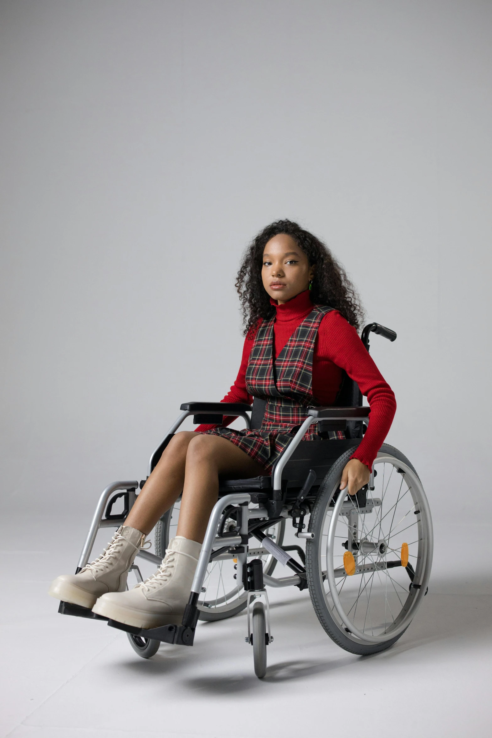 a young girl sitting in a wheel chair, an album cover, trending on pexels, hurufiyya, frontal pose, b - roll, ready to model, prostheses