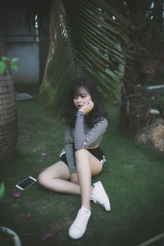 a woman sitting on the ground talking on a cell phone, by Tan Ting-pho, pexels contest winner, realism, 🤤 girl portrait, greenery, petite girl, round thighs