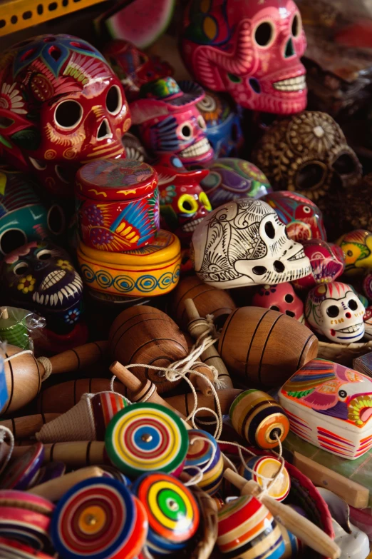 a pile of sugar skulls sitting on top of a table, toyism, musical instruments, slide show, travel, contain