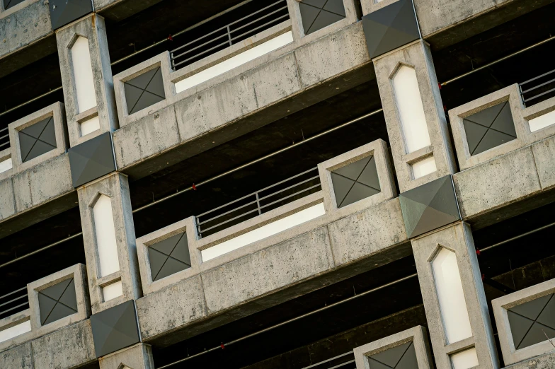 a clock on a pole in front of a building, a photo, inspired by Ricardo Bofill, unsplash, brutalism, concrete balcony, 1970s photo, high-angle, concrete pillars