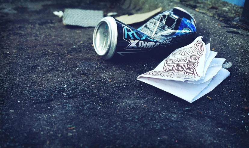 a can of soda sitting on top of a sidewalk, a picture, graffiti, paper cup, highly downvoted, scattered, pbr