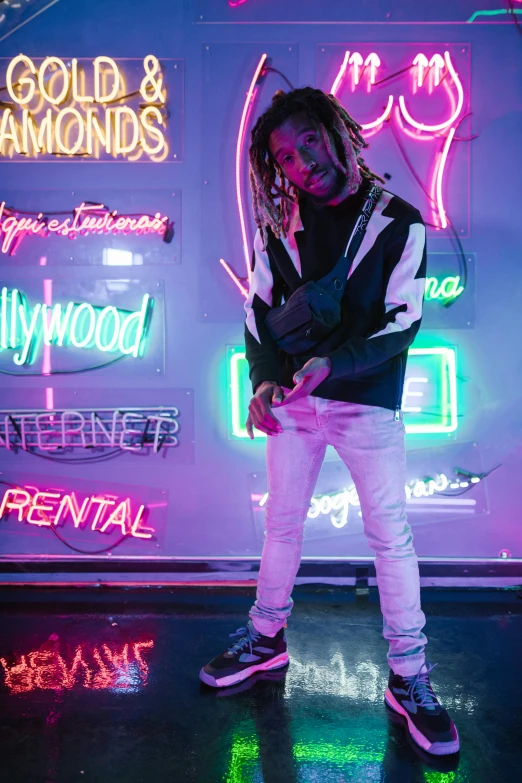 a man standing in front of a neon sign, an album cover, trending on pexels, dreads, hollywood standard, streetwear fashion, lil wayne