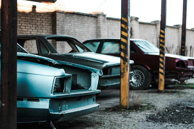 a couple of cars parked next to each other, unsplash, auto-destructive art, scrap metal on workbenches, 80s photo, profile image, fan favorite