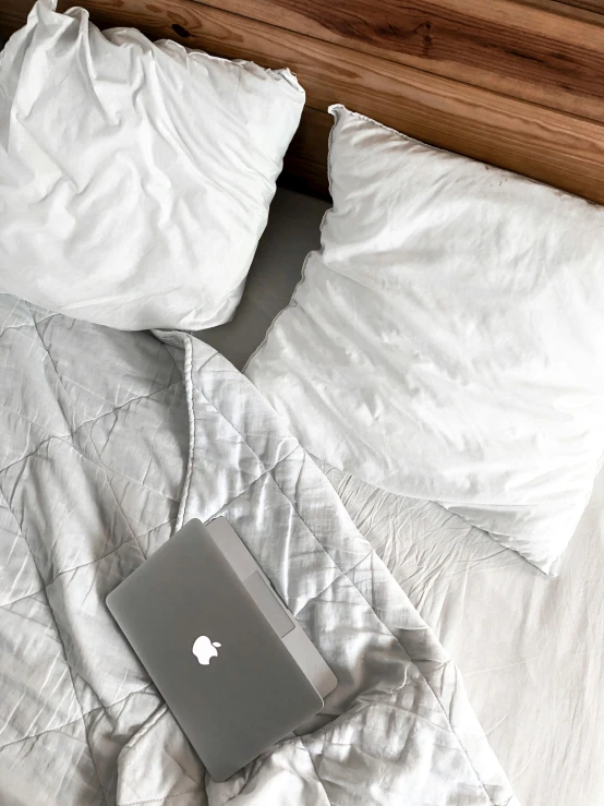 a bed with a laptop sitting on top of it, by Adam Rex, high angle close up shot, multiple stories, cleanest image, throw pillows