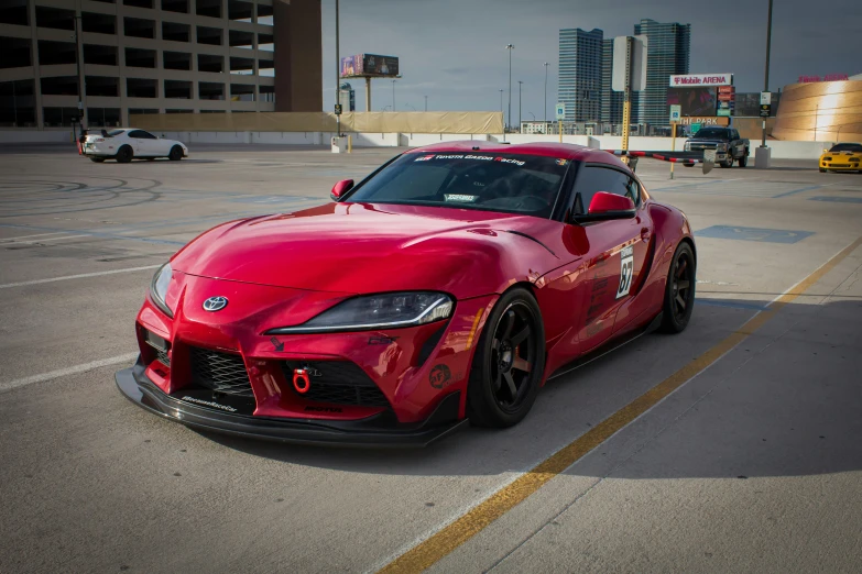 a red sports car parked in a parking lot, a portrait, unsplash, toyota supra, square, las vegas, high resolution print :1 red