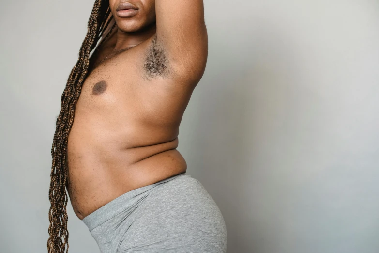a man with dreadlocks posing for a picture, trending on pexels, figuration libre, shapely toned derriere, with grey skin, obese ), furr covering her chest