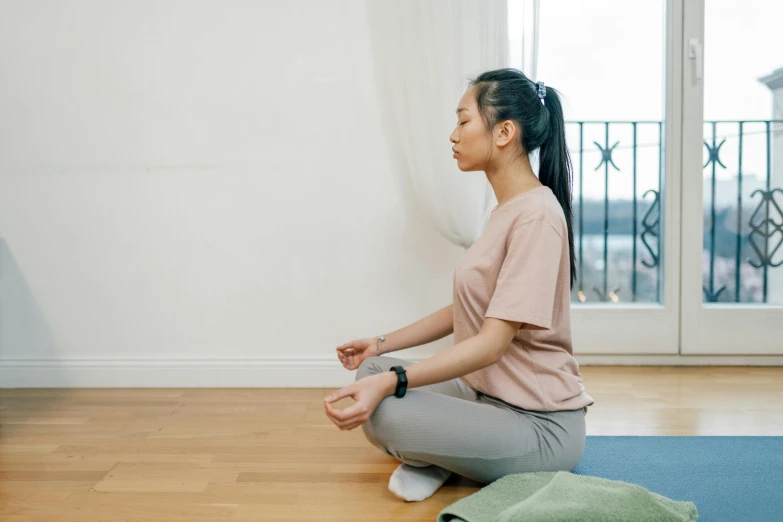 a woman sitting on the floor doing yoga, pexels contest winner, japanese collection product, low quality photo, animation, breathing