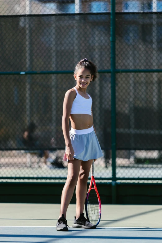 a young girl holding a tennis racquet on a tennis court, unsplash, happening, bare midriff, grey skirt, asher duran, promo image