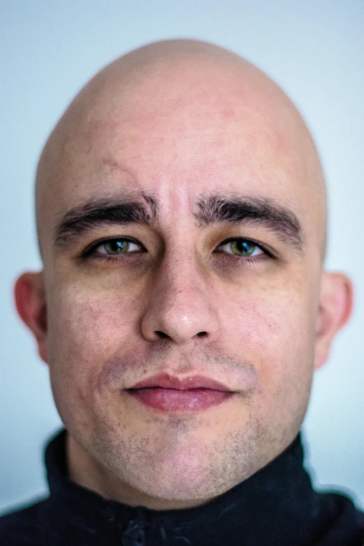 a close up of a person with a bald head, inspired by Carlos Berlanga, featured on reddit, heavy eyebrows, clean shaven, editorial image, color portrait