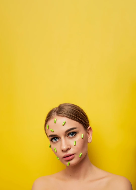 a woman with green sprinkles on her face, inspired by Martin Schoeller, trending on pexels, (((yellow))), sydney sweeney, geometry, natalia dyer