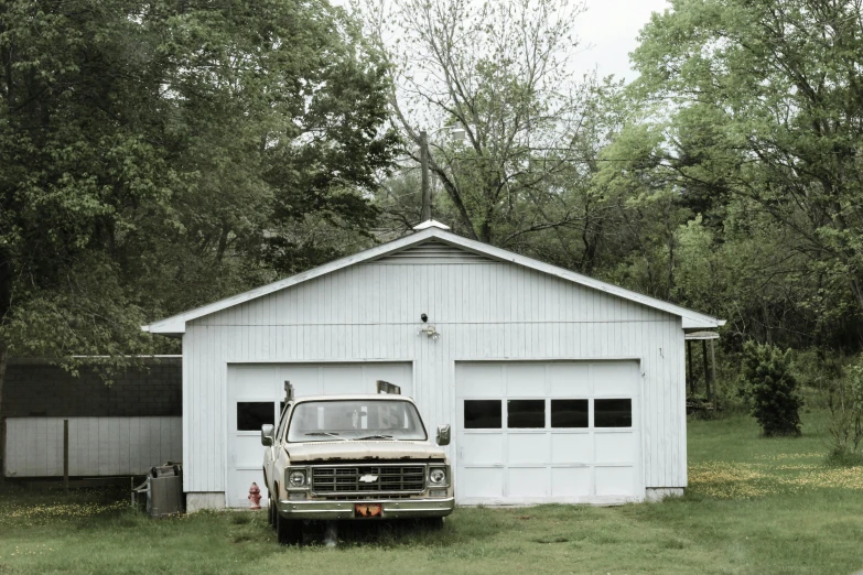 an old truck parked in front of a garage, by Carey Morris, high res photograph, suburban, jin kim, farmhouse
