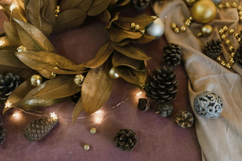 a close up of a wreath on a table, a still life, trending on pexels, brown and gold, tactile buttons and lights, brown and magenta color scheme, monochrome