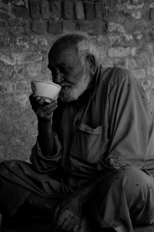 a black and white photo of a man drinking from a cup, by Riza Abbasi, wise old man, low colour, weary, then another